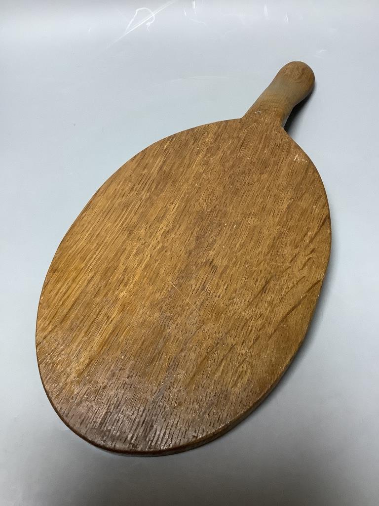 A 'Mouseman' carved wooden cheese board, length 37cm